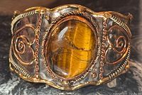 front view showing tiger eye stone and decorative scroll work