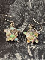 Both turtle earrings front view showing abalone inlay and hooks