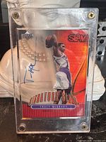 Front view of autographed Tracy McGrady Signature Slam card in plastic holder