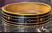 Front view showing black enamel and gilt motif