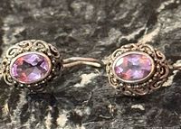 Front view of both earrings showing amethyst stones and filigree detail
