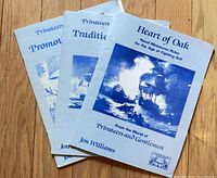 All three rulebook booklets fanned on wooden surface