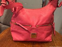 Front view showing color, logo plaque, exterior zip pocket