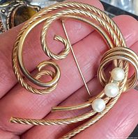 Front view showing entire brooch design and pearls