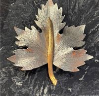 Front view of two-tone maple leaf brooch