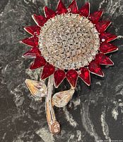 Front view showing red and clear rhinestone sunflower design