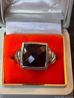 Front view of ring in box showing square faceted smoky quartz and sterling setting