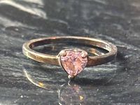 Front view of sterling silver ring with heart-shaped pink stone