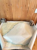 Rolled nautical chart showing shoreline and compass rose