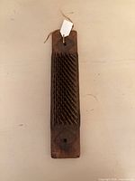 Top view showing full length wooden plank with iron spike comb