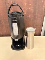 Front view of Zojirushi dispenser and Reduce jug