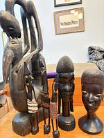 Group view of all five wooden carvings