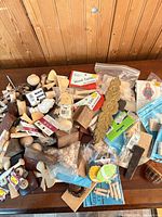 Overview of entire assortment on table showing variety of wooden pieces and packaged items