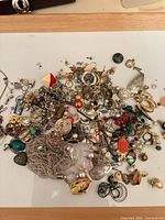 Overall view of mixed jewellery pieces on white board