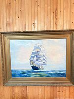 Full view of framed oil painting of sailing ship