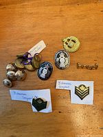 Group shot of all buttons, badges, pins and patches on table