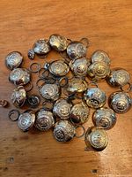 Group of 22 gold-tone domed buttons with shanks visible