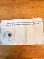 Legion pin in holder with maker and year note