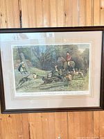 Full view of framed hunting scene print on wall