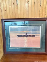 Full view of framed Danby print showing man in canoe with double mat and wooden frame