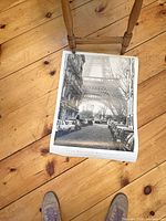 Clay Davidson photographic print on floor under chair