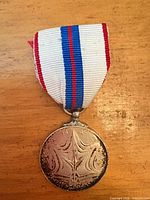Reverse side of medal with ribbon attached