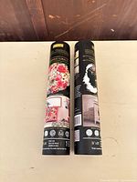 Two Re·Design decor transfer tubes upright on table