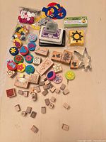 Overview of entire lot including wood stamps, foam stamps, mini alphabet stamps, foam shape bags, cutters and ink pads