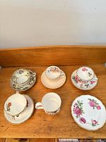 Group shot of all teacups, saucers, coffee cup and plate