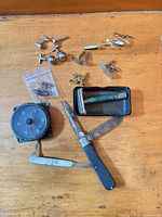 Overview of lot showing compass, razor in case, two pen knives and assorted cufflinks