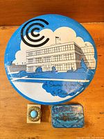 Closed Continental Can Co. tin, Edgeworth tin and pocket ashtray front view