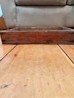 Front view of crate showing faded red Lunenburg Sea Products text