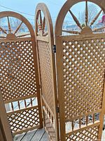 Full view showing three connected wooden lattice panels on deck