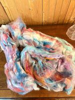 Bundle of multicolored merino wool roving on table