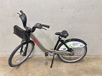 Full left side view of silver Bixi city bicycle showing frame, wheels, handlebars, rack