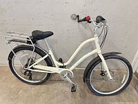 Full left side view showing complete bicycle, rear rack, fenders, drivetrain