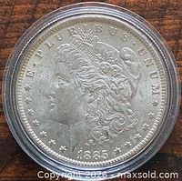 Obverse of 1885-O Morgan silver dollar in capsule