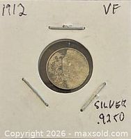 Coin secured in 2x2 holder, year and grade noted