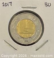 Obverse and reverse views of 2017 Vimy Ridge $2 coin in holder