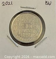 Coin in 2x2 holder showing reverse with Canadian Coat of Arms