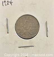 Coin in cardboard holder showing reverse date and denomination