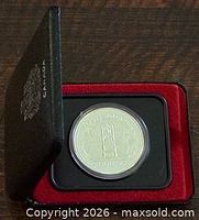 Coin in open presentation case showing overall packaging