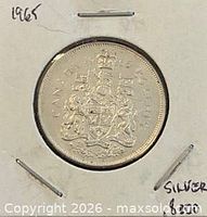 Coin in cardboard flip, reverse side showing Canadian coat of arms and date 1965