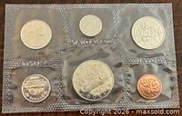 Front view of six-coin proof-like set in sealed plastic