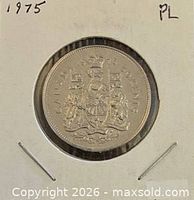 Coin in flip, reverse side showing Canadian Coat of Arms, year and PL noted
