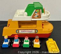 Overall shot of ferry boat, ramp, four cars with figures