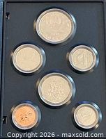 Front view of all six coins in specimen case