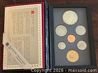 Open case showing certificate and seven proof coins