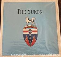 Front of sealed display card featuring Yukon coat of arms