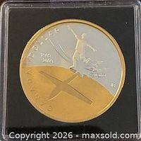 Reverse of coin showing aviator, aircraft and gold-plated segment